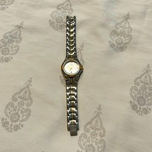 Anne Klein two-tone watch. Base metal bezel. Stainless steel back.